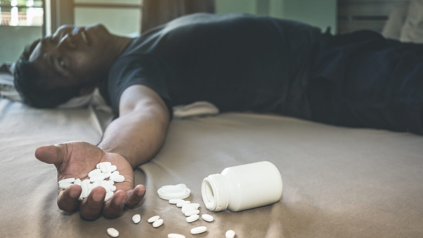Man With Medicines Lying Bed Home Scaled 1366x768